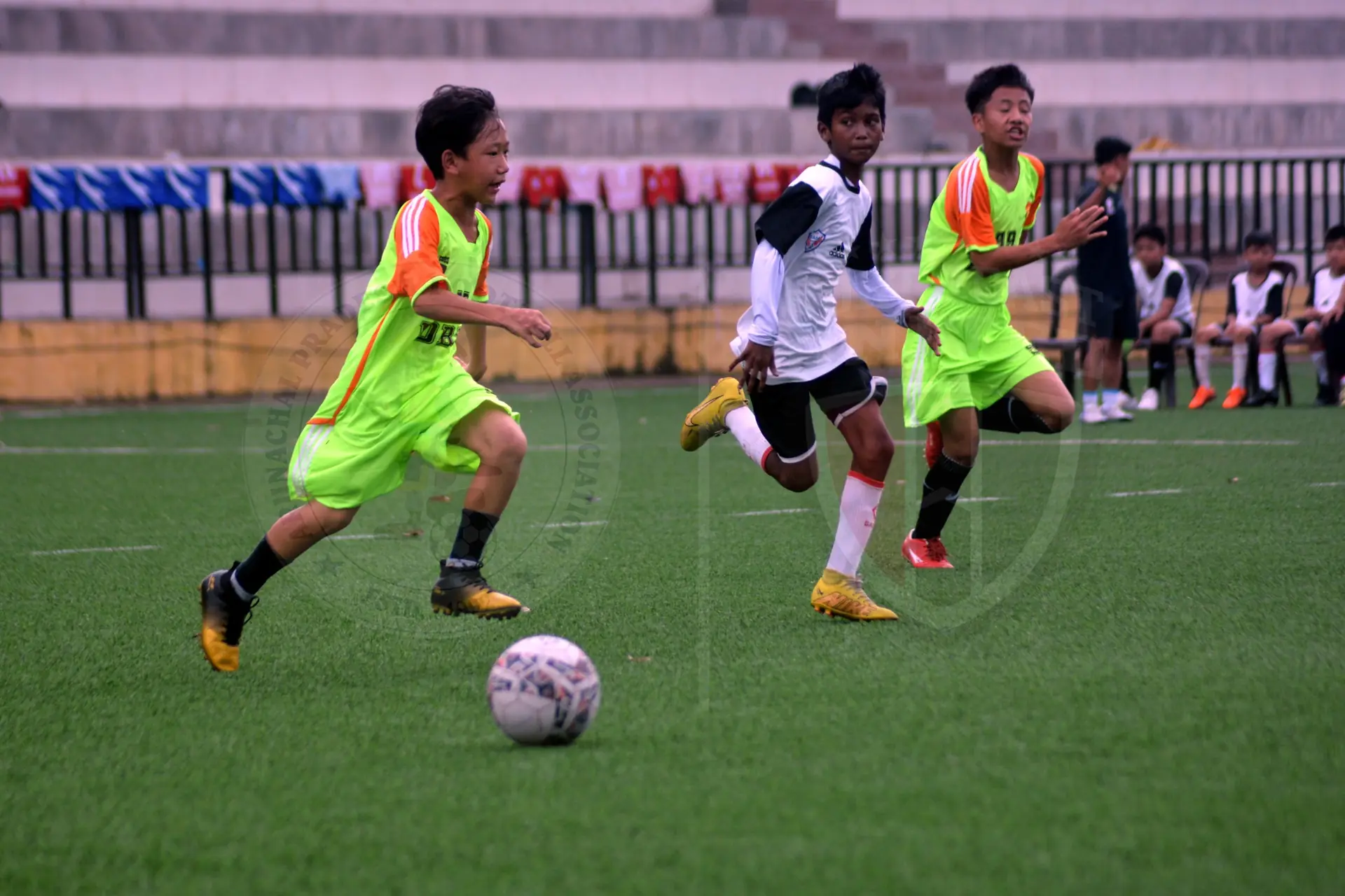 Young footballers chasing the ball during a match