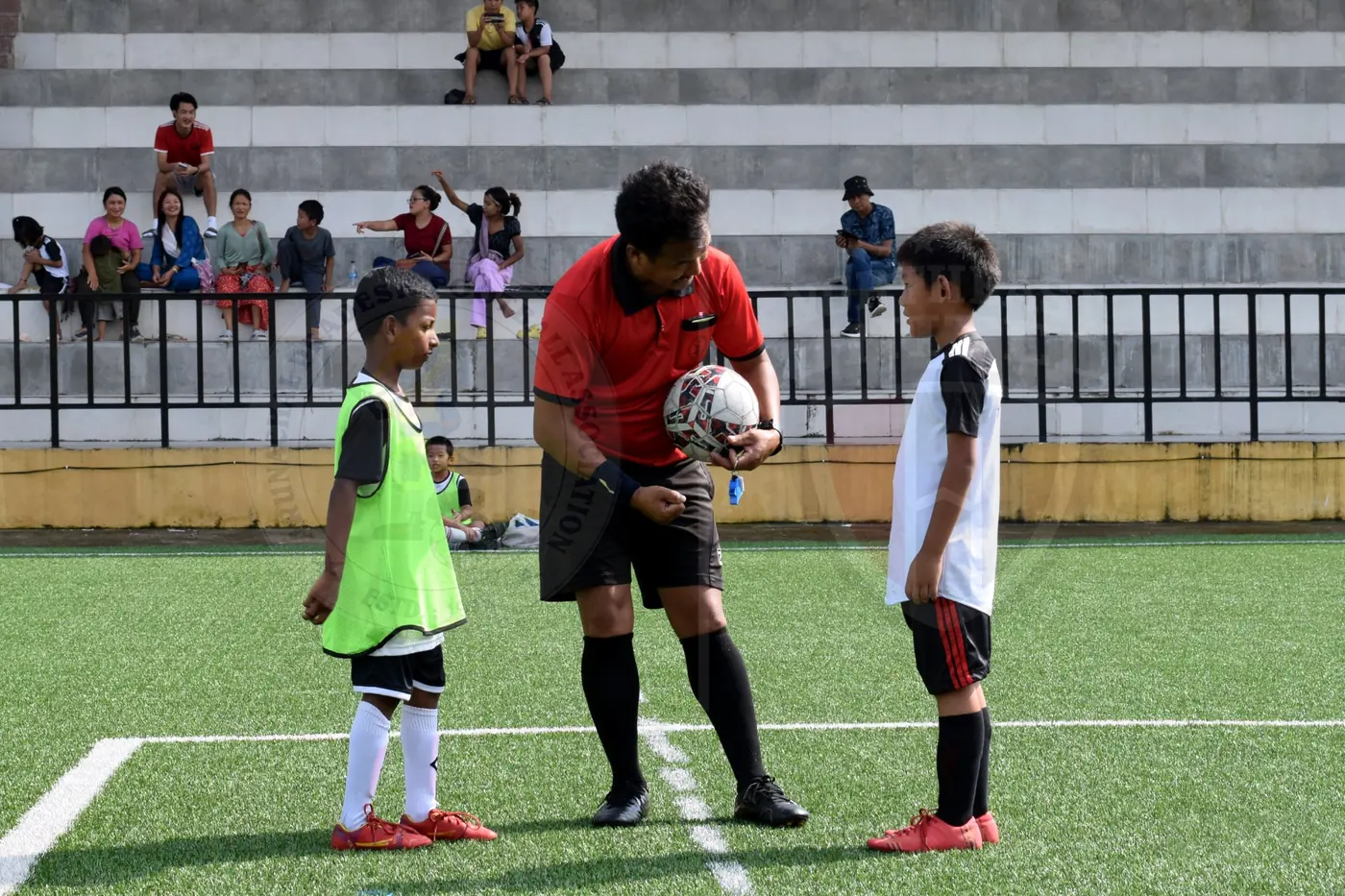 Referee explaining the game to young football players