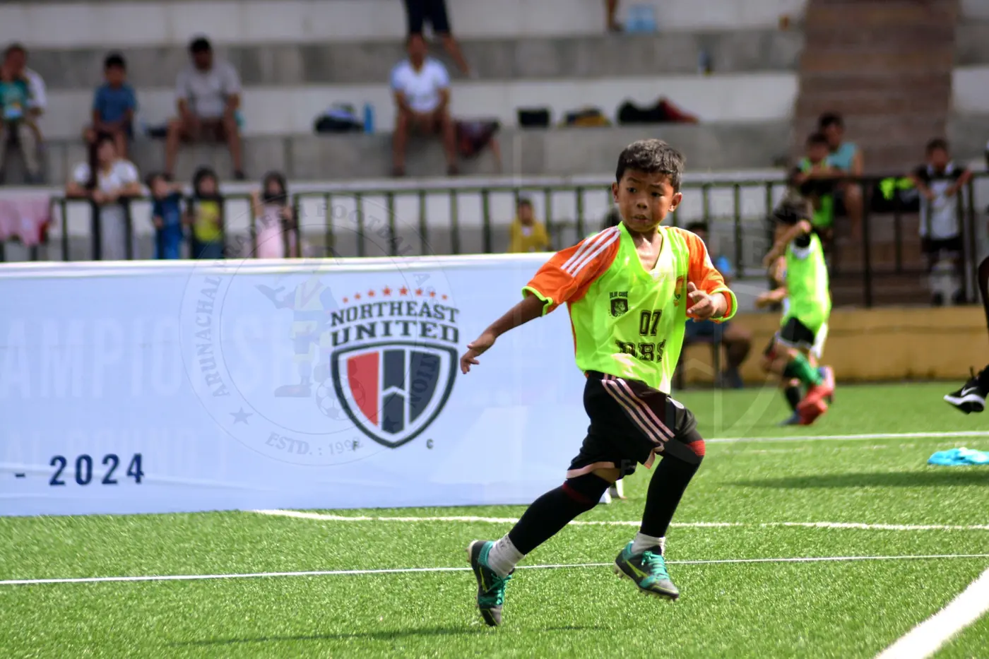 Young footballer running during a match